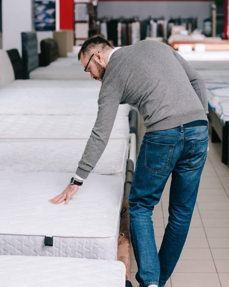 back-view-of-man-choosing-mattress-in-furniture-store-1.jpg